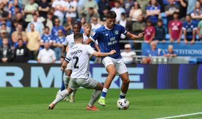 020825 - Cardiff City v Peterborough United, EFL Sky Bet League 1 - Rubin Colwill of Cardiff City takes on Carl Johnston of Peterborough United