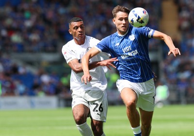 020825 - Cardiff City v Peterborough United, EFL Sky Bet League 1 - Rubin Colwill of Cardiff City and David Okagbue of Peterborough United compete for the ball