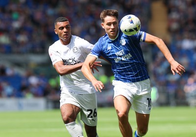 020825 - Cardiff City v Peterborough United, EFL Sky Bet League 1 - Rubin Colwill of Cardiff City and David Okagbue of Peterborough United compete for the ball