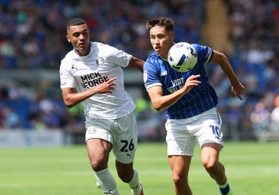 020825 - Cardiff City v Peterborough United, EFL Sky Bet League 1 - Rubin Colwill of Cardiff City and David Okagbue of Peterborough United compete for the ball