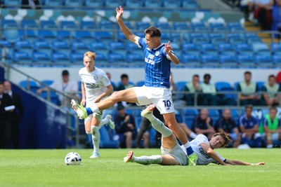 020825 - Cardiff City v Peterborough United, EFL Sky Bet League 1 - Rubin Colwill of Cardiff City wins the ball from Oscar Wallin of Peterborough United