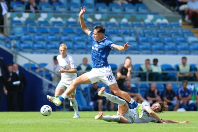 020825 - Cardiff City v Peterborough United, EFL Sky Bet League 1 - Rubin Colwill of Cardiff City wins the ball from Oscar Wallin of Peterborough United