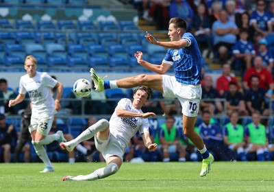 020825 - Cardiff City v Peterborough United, EFL Sky Bet League 1 - Rubin Colwill of Cardiff City wins the ball from Oscar Wallin of Peterborough United