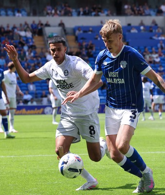 020825 - Cardiff City v Peterborough United, EFL Sky Bet League 1 - Joel Bagan of Cardiff City looks to hold off Brandon Khela of Peterborough United