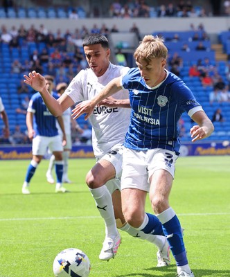 020825 - Cardiff City v Peterborough United, EFL Sky Bet League 1 - Joel Bagan of Cardiff City looks to hold off Brandon Khela of Peterborough United