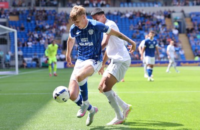 020825 - Cardiff City v Peterborough United, EFL Sky Bet League 1 - Joel Bagan of Cardiff City looks to hold off Brandon Khela of Peterborough United