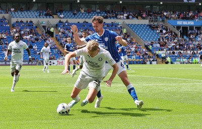 020825 - Cardiff City v Peterborough United, EFL Sky Bet League 1 - Harley Mills of Peterborough United is brought down by Ryan Wintle of Cardiff City
