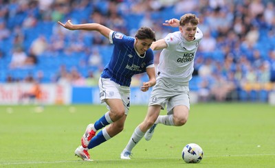 020825 - Cardiff City v Peterborough United, EFL Sky Bet League 1 - Joel Colwill of Cardiff City and George Nevett of Peterborough United compete for the ball