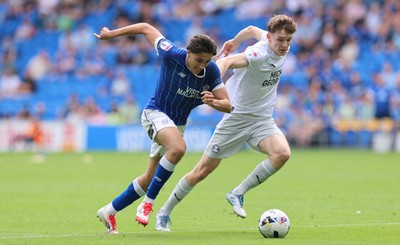 020825 - Cardiff City v Peterborough United, EFL Sky Bet League 1 - Joel Colwill of Cardiff City and George Nevett of Peterborough United compete for the ball