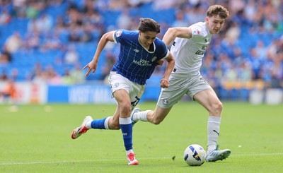 020825 - Cardiff City v Peterborough United, EFL Sky Bet League 1 - Joel Colwill of Cardiff City and George Nevett of Peterborough United compete for the ball