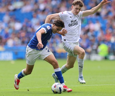 020825 - Cardiff City v Peterborough United, EFL Sky Bet League 1 - Joel Colwill of Cardiff City and George Nevett of Peterborough United compete for the ball
