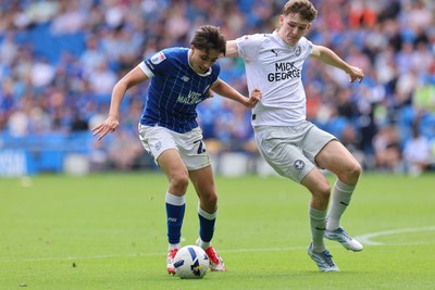 020825 - Cardiff City v Peterborough United, EFL Sky Bet League 1 - Joel Colwill of Cardiff City and George Nevett of Peterborough United compete for the ball