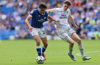 020825 - Cardiff City v Peterborough United, EFL Sky Bet League 1 - Joel Colwill of Cardiff City and George Nevett of Peterborough United compete for the ball