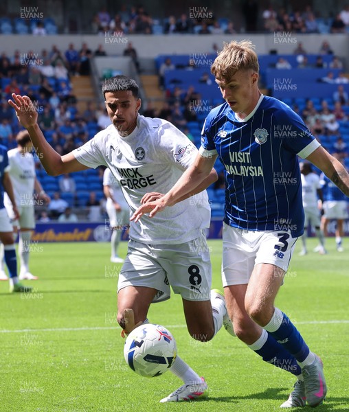 020825 - Cardiff City v Peterborough United, EFL Sky Bet League 1 - Joel Bagan of Cardiff City looks to hold off Brandon Khela of Peterborough United