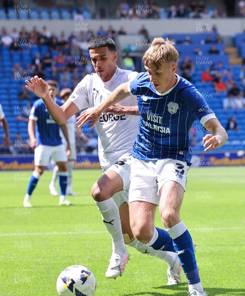 020825 - Cardiff City v Peterborough United, EFL Sky Bet League 1 - Joel Bagan of Cardiff City looks to hold off Brandon Khela of Peterborough United