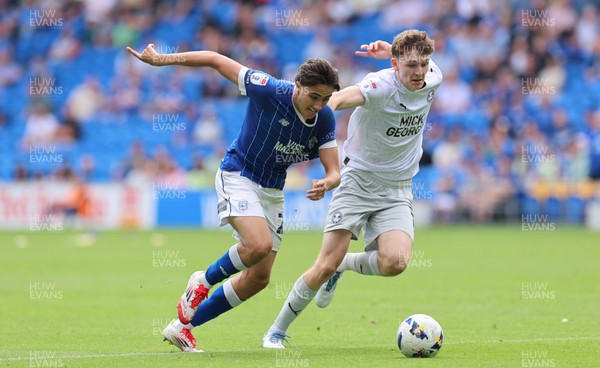 020825 - Cardiff City v Peterborough United, EFL Sky Bet League 1 - Joel Colwill of Cardiff City and George Nevett of Peterborough United compete for the ball