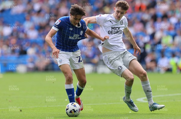 020825 - Cardiff City v Peterborough United, EFL Sky Bet League 1 - Joel Colwill of Cardiff City and George Nevett of Peterborough United compete for the ball