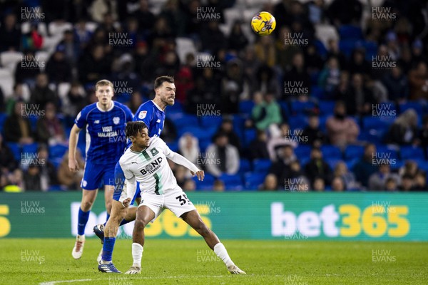 261223 - Cardiff City v Plymouth Argyle - Sky Bet Championship - Dimitris Goutas of Cardiff City wins a header over Freddie Issaka of Plymouth Argyle