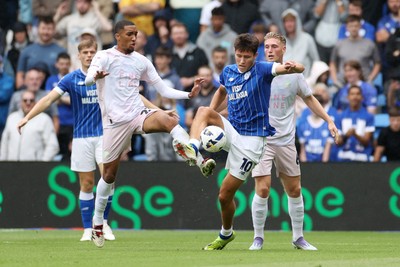 300825 - Cardiff City v Plymouth Argyle, SkyBet League One - Rubin Colwill of Cardiff City is challenged by Bradley Ibrahim of Plymouth Argyle 