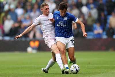 300825 - Cardiff City v Plymouth Argyle, SkyBet League One - Rubin Colwill of Cardiff City is tackled by Kornel Szucs of Plymouth Argyle 