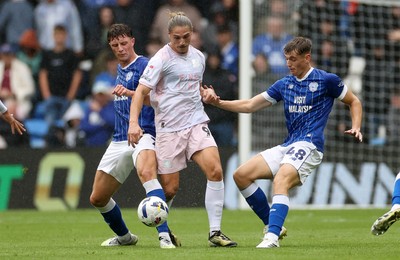 300825 - Cardiff City v Plymouth Argyle, SkyBet League One - Lorent Tolaj of Plymouth Argyle is tackled by William Fish and Dylan Lawlor of Cardiff City 