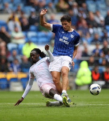 300825 - Cardiff City v Plymouth Argyle, SkyBet League One - Rubin Colwill of Cardiff City is tackled by Malachi Boateng of Plymouth Argyle 
