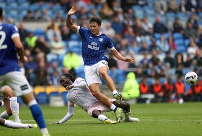 300825 - Cardiff City v Plymouth Argyle, SkyBet League One - Rubin Colwill of Cardiff City is tackled by Malachi Boateng of Plymouth Argyle 
