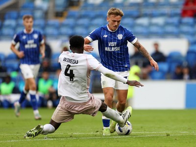 300825 - Cardiff City v Plymouth Argyle, SkyBet League One - Isaak Davies of Cardiff City is challenged by Brendan Wiredu of Plymouth Argyle 