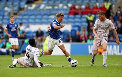 300825 - Cardiff City v Plymouth Argyle, SkyBet League One - Isaak Davies of Cardiff City is challenged by Brendan Wiredu of Plymouth Argyle 