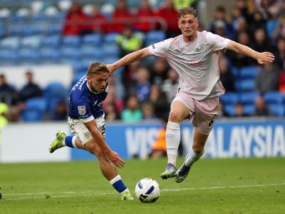 300825 - Cardiff City v Plymouth Argyle, SkyBet League One - Isaak Davies of Cardiff City is challenged by Kornel Szucs of Plymouth Argyle 