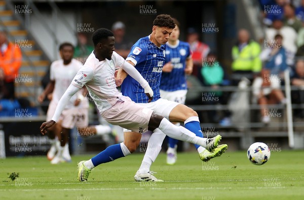 300825 - Cardiff City v Plymouth Argyle, SkyBet League One - Yousef Salech of Cardiff City is tackled by Brendan Wiredu of Plymouth Argyle 