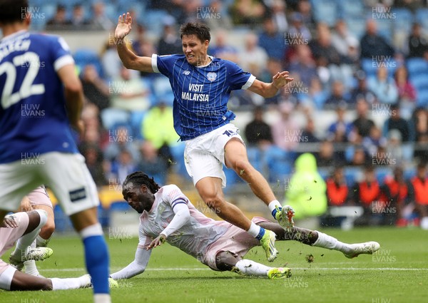 300825 - Cardiff City v Plymouth Argyle, SkyBet League One - Rubin Colwill of Cardiff City is tackled by Malachi Boateng of Plymouth Argyle 