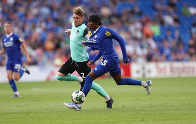 090822 - Cardiff City v Portsmouth, EFL Carabao Cup - Jaden Philogene of Cardiff City and Zak Swanson of Portsmouth compete for the ball