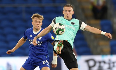 090822 - Cardiff City v Portsmouth, EFL Carabao Cup - Ronan Curtis of Portsmouth controls the ball as Eli King of Cardiff City looks on