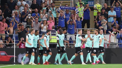 090822 - Cardiff City v Portsmouth, EFL Carabao Cup - Portsmouth players celebrate in front of their fans after scoring the third goal