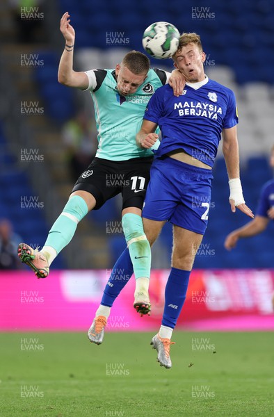 090822 - Cardiff City v Portsmouth, EFL Carabao Cup - Eli King of Cardiff City and Ronan Curtis of Portsmouth compete for the ball