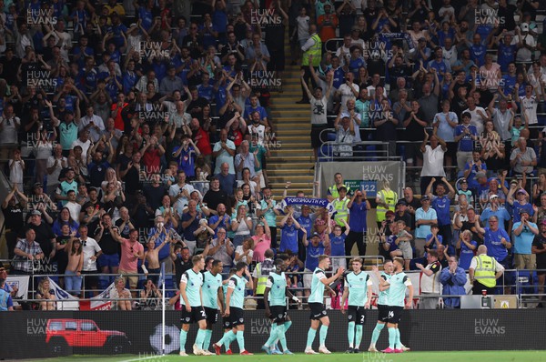 090822 - Cardiff City v Portsmouth, EFL Carabao Cup - Portsmouth players celebrate in front of their fans after scoring the third goal
