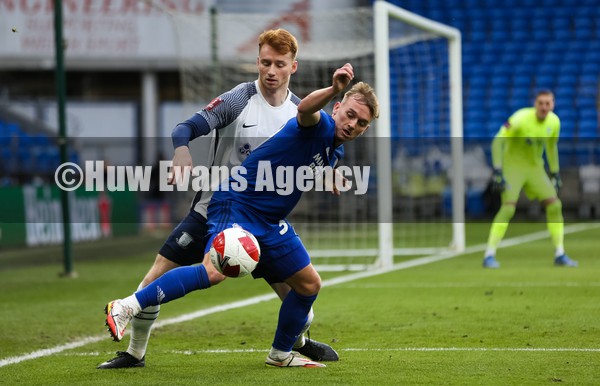 090122 - Cardiff City v Preston North End, FA Cup - Isaak Davies of Cardiff City and Sepp van den Berg of Preston North End compete for the ball