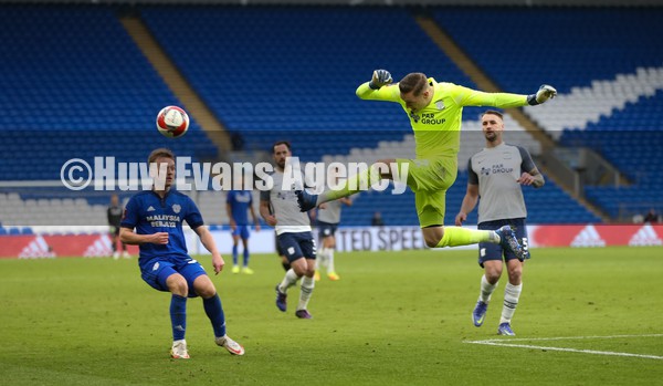 090122 - Cardiff City v Preston North End, FA Cup - Preston North End goalkeeper Daniel Iversen clears the ball as Isaak Davies of Cardiff City closes in