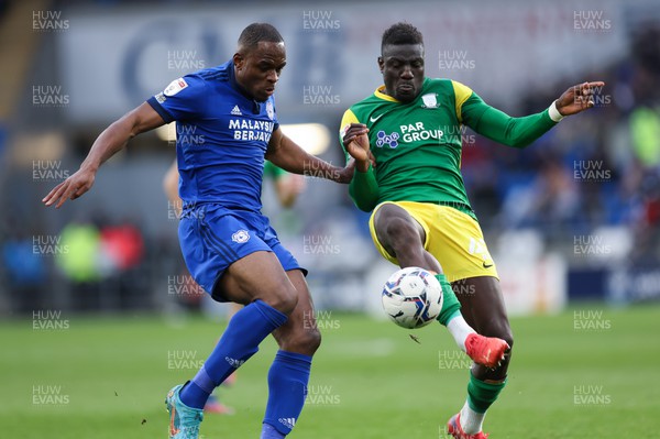120322 Cardiff City v Preston North End, Sky Bet Championship - Uche Ikpeazu of Cardiff City tangles with Bambo Diary of Preston North End as he looks to win the ball