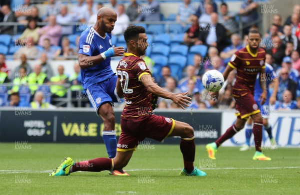 140816 - Cardiff City v Queens Park Rangers, Football League Championship - Frederic Gounongbe of Cardiff City has his shot blocked by Steven Caulker of Queens Park Rangers