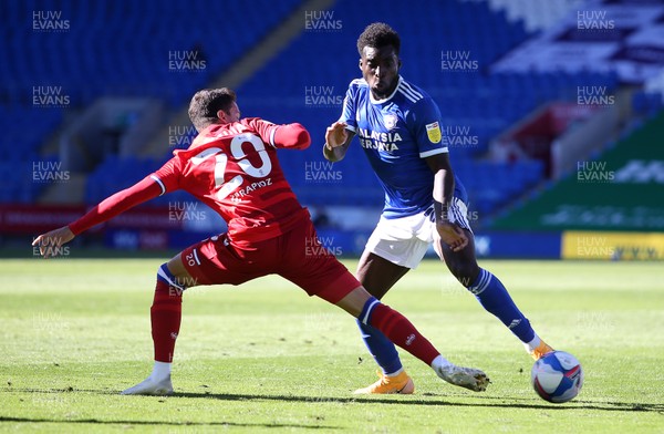 260920 - Cardiff City v Reading - SkyBet Championship - Sheyi Ojo of Cardiff City is tackled by Araruna of Reading