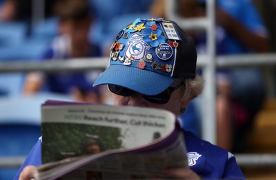 290826 - Cardiff City v Sheffield United - SkyBet Championship - A Cardiff fan reads the paper