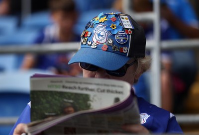 290826 - Cardiff City v Sheffield United - SkyBet Championship - A Cardiff fan reads the paper
