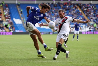290826 - Cardiff City v Sheffield United - SkyBet Championship - Rubin Colwill of Cardiff City is challenged by Rhys Norrington-Davies of Sheffield United 