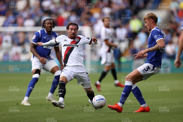 290826 - Cardiff City v Sheffield United - SkyBet Championship - Joe Rothwell of Sheffield United is challenged by Joel Bagan of Cardiff City 