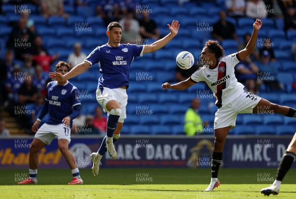 290826 - Cardiff City v Sheffield United - SkyBet Championship - Yousef Salech of Cardiff City and Sam McCallum of Sheffield United go for the ball
