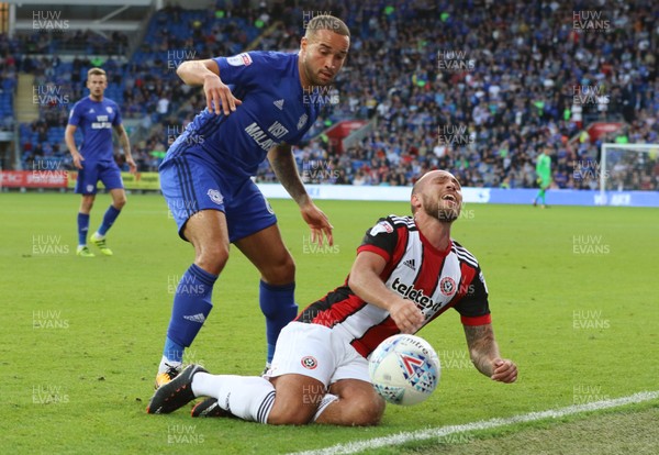 150817 - Cardiff City v Sheffield United, Sky Bet Championship - Samir Carruthers of Sheffield United goes down under the challenge from Jazz Richards of Cardiff City