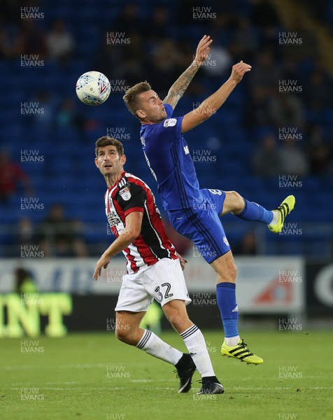150817 - Cardiff City v Sheffield United, Sky Bet Championship - Joe Ralls of Cardiff City gets above Ched Evans of Sheffield United to head the ball