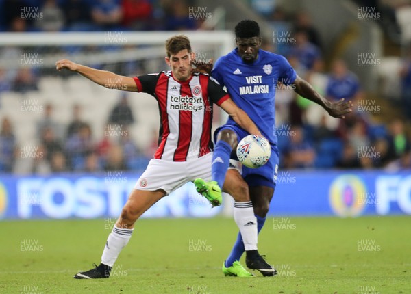 150817 - Cardiff City v Sheffield United, Sky Bet Championship - Bruno Ecuele Manga of Cardiff City and Ched Evans of Sheffield United compete for the ball